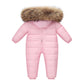 The Baby Wears White Eiderdown Over A Onesie And Down Jacket