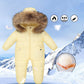 The Baby Wears White Eiderdown Over A Onesie And Down Jacket